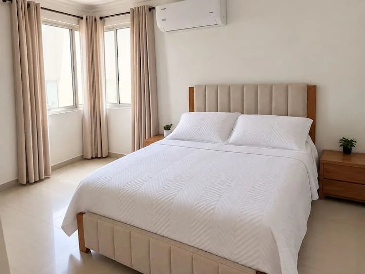 Dormitorio con cama doble y cortinas claras — Mar Adentro 1305